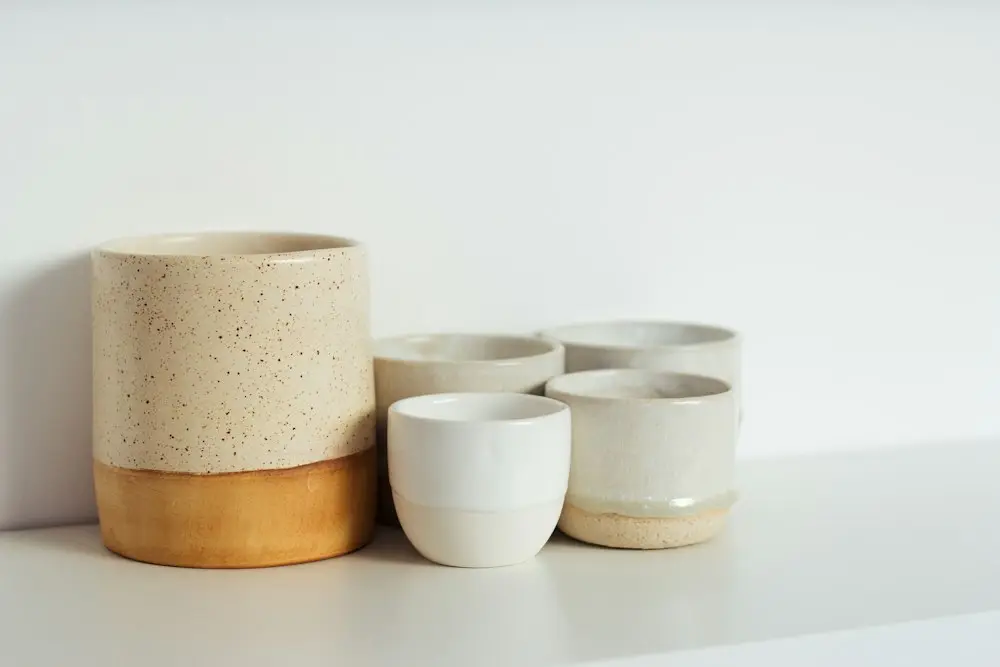 Speckled stoneware cups with a gold-glazed base
